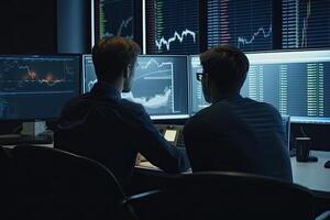 back view of two businessmen working together in the office Discuss and monitor global currency indices in exchange-traded funds. photo