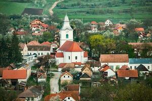 Rimetea is a small village located in Transylvania, Romania. It is situated in the Apuseni Mountains and is known for its picturesque setting and well preserved Hungarian architectural style. photo