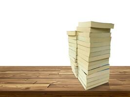 stack of books on wooden table isolated on white background photo