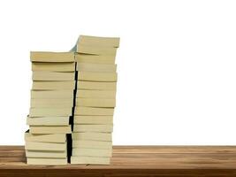 stack of books on wooden table isolated on white background photo