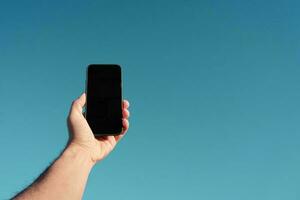 mano participación un móvil teléfono, móvil teléfono adiccion foto