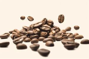 Falling coffee beans and freshly roasted coffee beans on beige background. photo