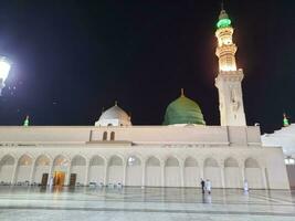 Medina, Saudi Arabia, May 2023 - Beautiful view of Masjid Al Nabawi, Medina, high minarets and mosque at night. The mosque presents a beautiful scene in the night lights. photo