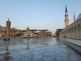 Beautiful daytime view of Masjid Al Nabawi, Medina's minarets and mosque courtyard. photo