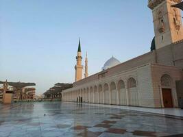 Beautiful daytime view of Masjid Al Nabawi, Medina's minarets and mosque courtyard. photo