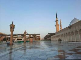 Beautiful daytime view of Masjid Al Nabawi, Medina's minarets and mosque courtyard. photo