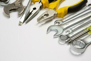 Set of tools for repair in a case on a white background. Assorted work or construction tools. Wrenches, Pliers, screwdriver. Top view photo