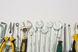 Set of tools for repair in a case on a white background. Assorted work or construction tools. Wrenches, Pliers, screwdriver. Top view photo