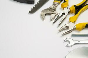 Set of tools for repair in a case on a white background. Assorted work or construction tools. Wrenches, Pliers, screwdriver. Top view photo