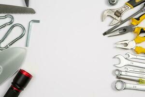 Set of tools for repair in a case on a white background. Assorted work or construction tools. Wrenches, Pliers, screwdriver. Top view photo