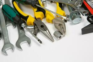 Set of tools for repair in a case on a white background. Assorted work or construction tools. Wrenches, Pliers, screwdriver. Top view photo