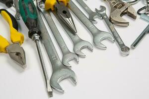 Set of tools for repair in a case on a white background. Assorted work or construction tools. Wrenches, Pliers, screwdriver. Top view photo