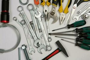 Set of tools for repair in a case on a white background. Assorted work or construction tools. Wrenches, Pliers, screwdriver. Top view photo