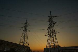 High-voltage power lines at sunset. Electricity distribution station.  electricity pylons on the background of the sky photo