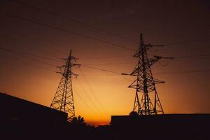 High-voltage power lines at sunset. Electricity distribution station.  electricity pylons on the background of the sky photo