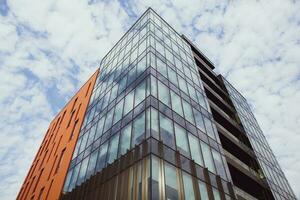 Modern office building with glass facade and blue sky. Business background. modern architecture in the city photo