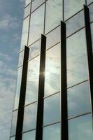 Modern office building with glass facade and blue sky. Business background. modern architecture in the city photo