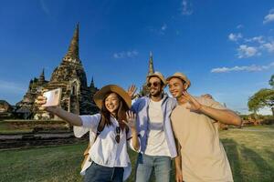 Tourists take selfie photo at Wat Phra Si Sanphet temple, Ayutthaya Thailand, for travel, vacation, holiday, honeymoon and tourism concept