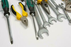 Set of tools for repair in a case on a white background. Assorted work or construction tools. Wrenches, Pliers, screwdriver. Top view photo