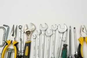 Set of tools for repair in a case on a white background. Assorted work or construction tools. Wrenches, Pliers, screwdriver. Top view photo