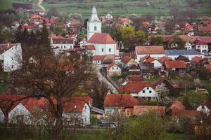 Rimetea is a small village located in Transylvania, Romania. It is situated in the Apuseni Mountains and is known for its picturesque setting and well preserved Hungarian architectural style. photo