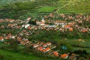 Rimetea is a small village located in Transylvania, Romania. It is situated in the Apuseni Mountains and is known for its picturesque setting and well preserved Hungarian architectural style. photo