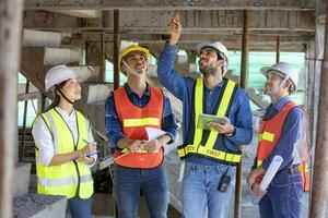 Team of engineer, architect, contractor and foreman meeting and consulting in construction building site for inspection in real estate development project industry and specification quality control photo