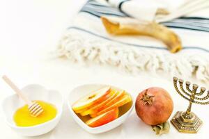 Rosh Hashanah jewish new year holiday celebration concept. Honey and apples over white background. photo