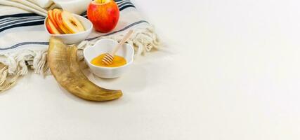 Rosh hashanah jewish new year holiday celebration concept. Honey and apples over white background. photo