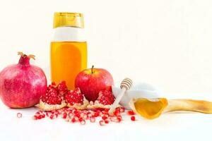 Apple, honey, ram's horn and pomegranate on white background. Jewish New Year - Rosh Hashana concept. photo