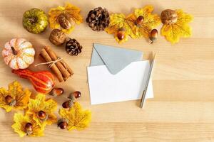 Festive autumn decor from pumpkins, and leaves on a wooden background. Concept of Thanksgiving day. Flat lay autumn composition with copy space. photo