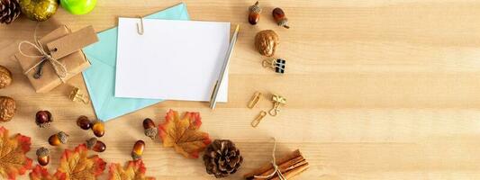 Thanksgiving background pumpkins and fallen leaves on wooden background. Thanksgiving day or seasonal background. photo