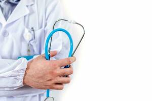 Close-up of male doctor holding stethoscope. photo