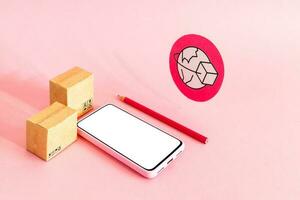 Smart phone with blank screen and cardboard boxes on pink background. Online shopping and global delivery service concept. photo