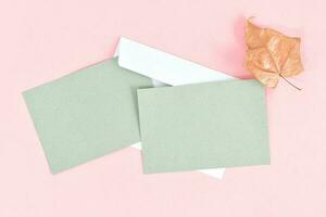 Greeting card mockup with envelope on pink background. Card mockup with copy space. photo