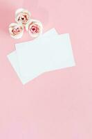 Blank white greeting card with pink rose flowers. Mock up. photo