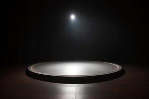 a circular platform podium with white neon light on dark background. photo