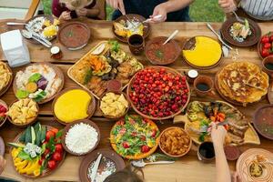 Homemade Romanian Food with grilled meat, polenta and vegetables Platter on camping. Romantic traditional moldavian food outside on the wood table. photo