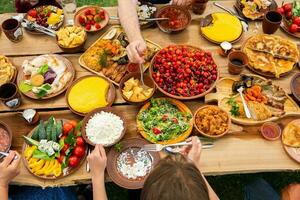 Homemade Romanian Food with grilled meat, polenta and vegetables Platter on camping. Romantic traditional moldavian food outside on the wood table. photo