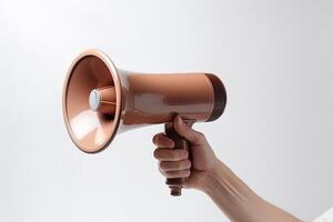 The hand holds a blue megaphone on a brown background. Announcement concept. Shout It Out. photo