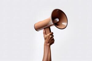 The hand holds a blue megaphone on a brown background. Announcement concept. Shout It Out. photo
