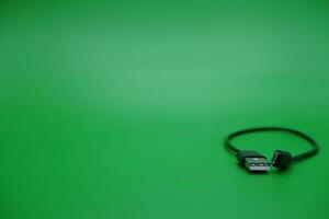 USB type A cable to USB micro B cable isolated green background. photo