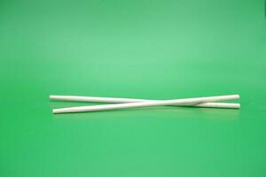 chopsticks isolated green background photo