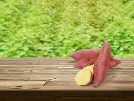 sweet potato on wooden table There is a garden field in the background. photo