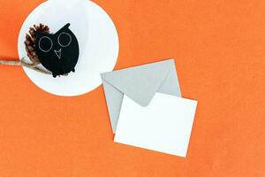 Halloween background with owl, card and envelope, on orange background. photo