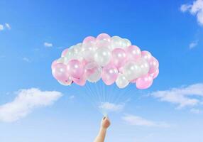 Boy hand with colorful balloons on bright sky background. photo