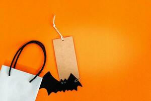 Halloween sale banner with label and bag on orange background. photo