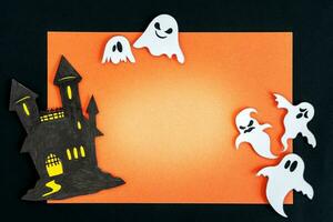 Scary halloween ghosts and castle, on orange and black background. photo