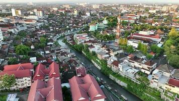 Aerial view of housing in Yogyakarta city at sunset with view of Mount Merapi in the distance, Indonesia. video