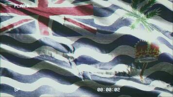 VHS video casette record British Indian Ocean Territory flag waving on the wind. Glitch noise with time counter recording banner swaying on the breeze. Seamless loop.